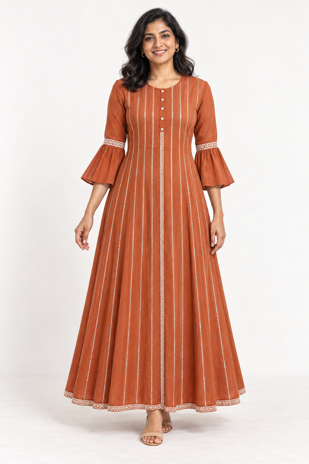 Smiling model wearing a rust flared dress with bell sleeves, vertical silver lines and ivory lace trim