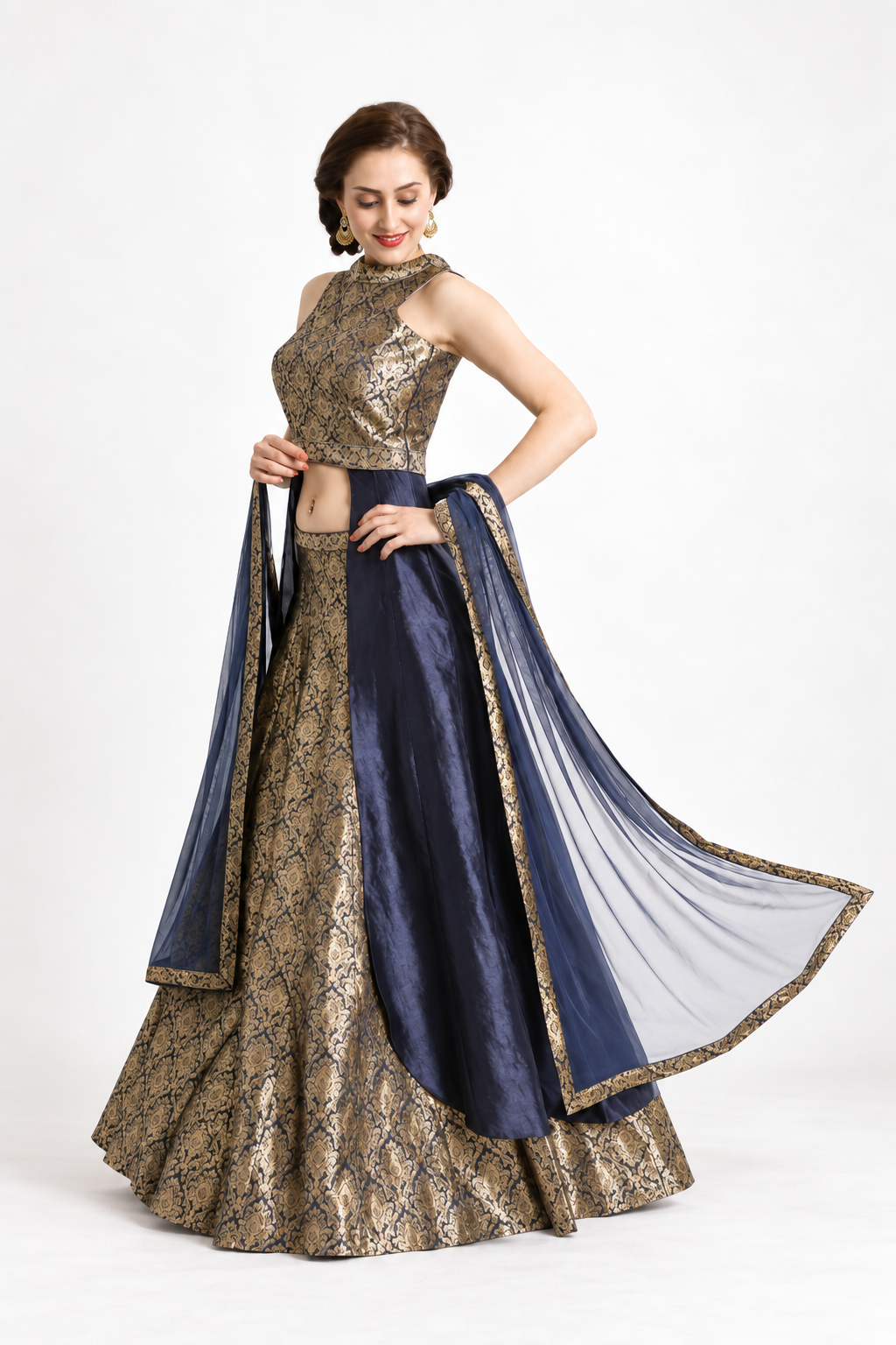 Smiling model wearing a navy and antique gold lehenga with a flowing dupatta